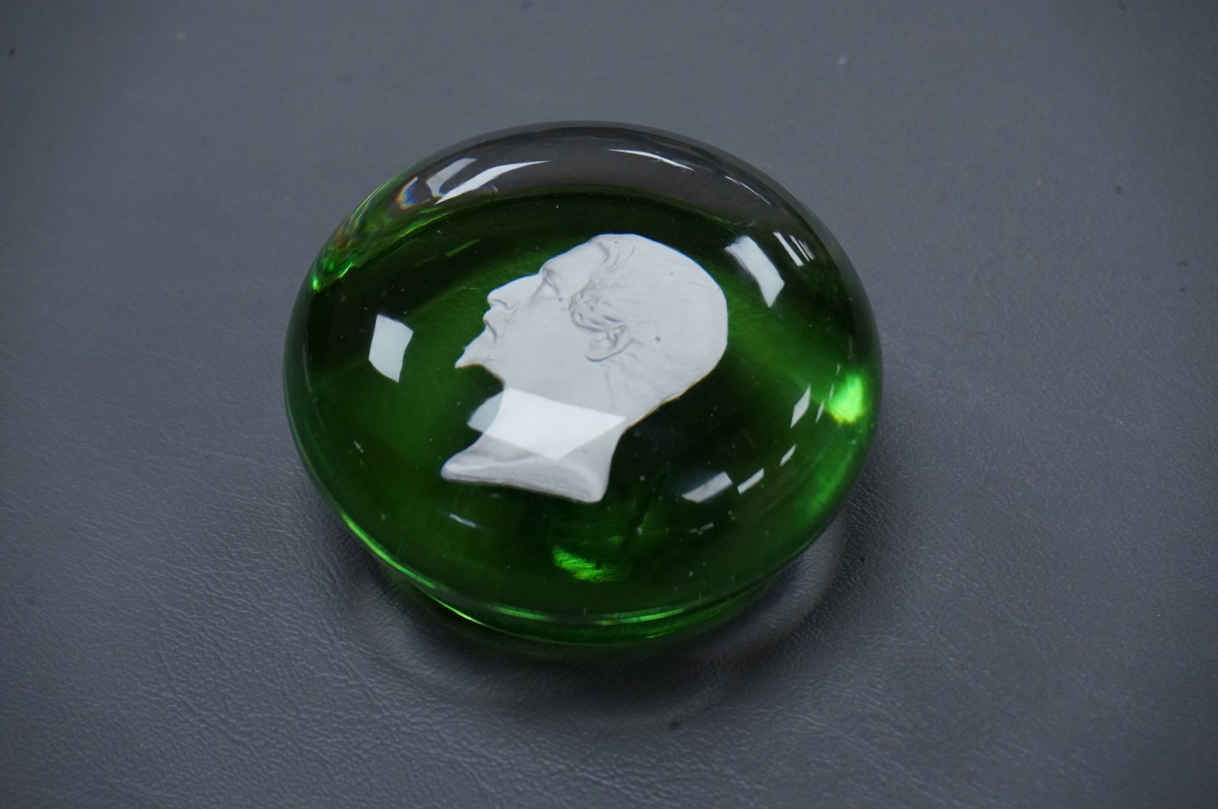 A Clichy Napoleon III sulphide paperweight, green pedestal foot. base 6cm diameter.